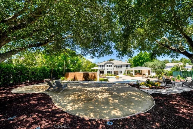 a bedroom with a large bed and a potted plant