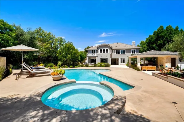 a spacious bathroom with a granite countertop sink and a mirror