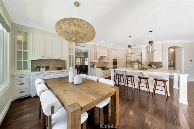 an open kitchen with white cabinets and stainless steel appliances