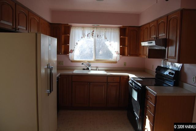 1445 Kings Row Reno, NV 89503 - Photo 2 of 9 a kitchen with stainless steel appliances granite countertop a refrigerator and a stove