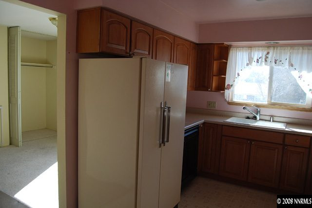 1445 Kings Row Reno, NV 89503 - Photo 3 of 9 a kitchen with stainless steel appliances granite countertop a refrigerator and a sink