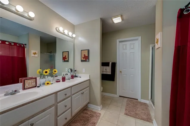 a spacious bathroom with a sink mirror vanity and shower