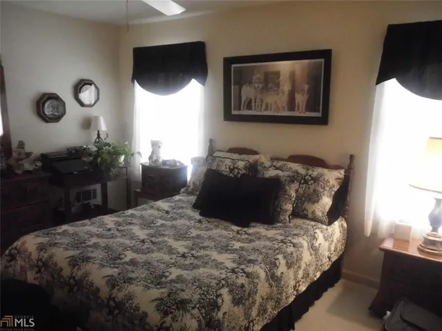 a bed sitting in a bedroom next to a window