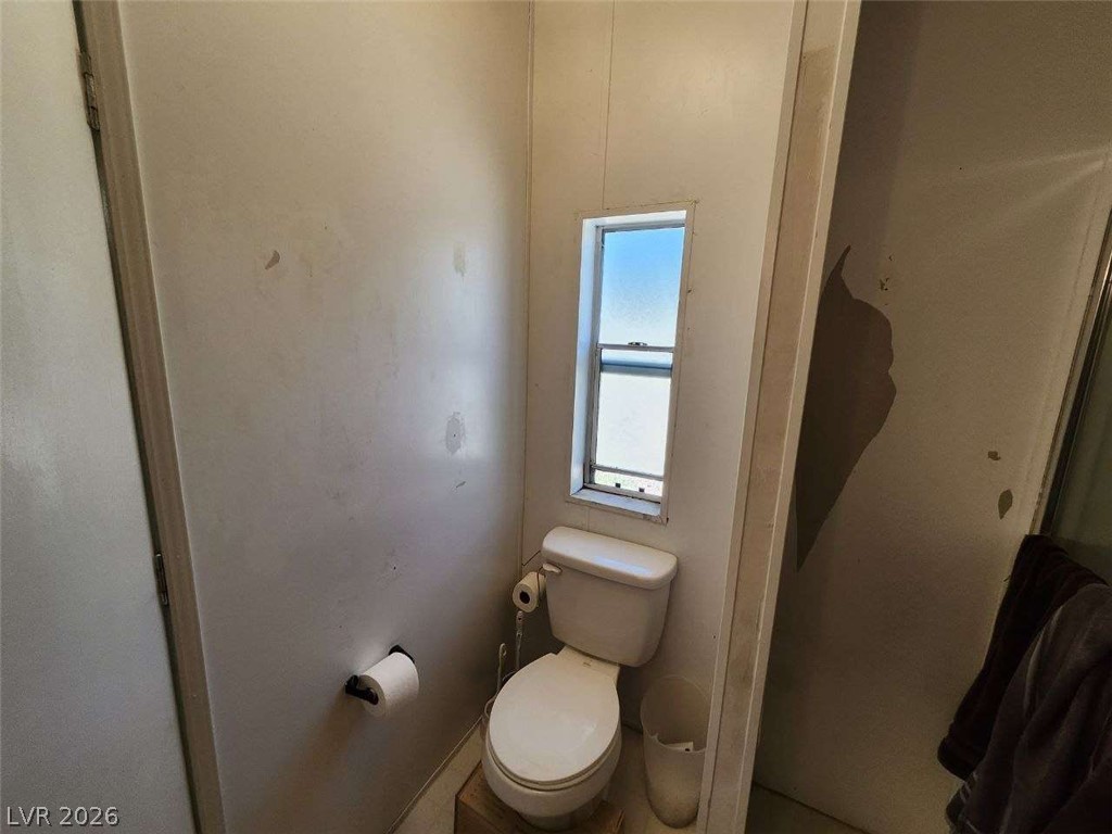 942 Holt Caliente, NV 89008 - Photo 19 of 22 A compact bathroom featuring a window above the toilet, offering natural light.