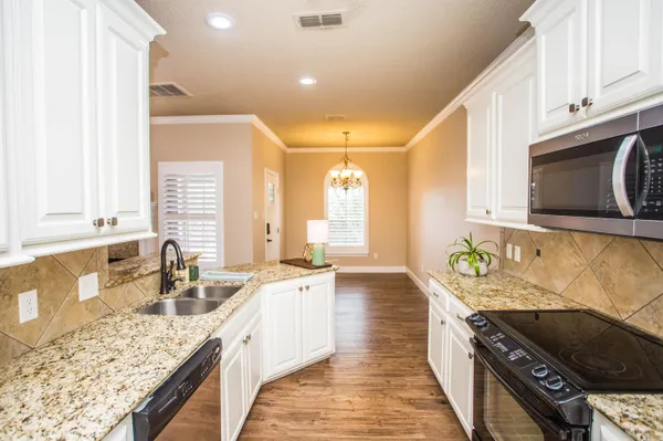a bathroom with a double vanity sink a mirror and a bathtub