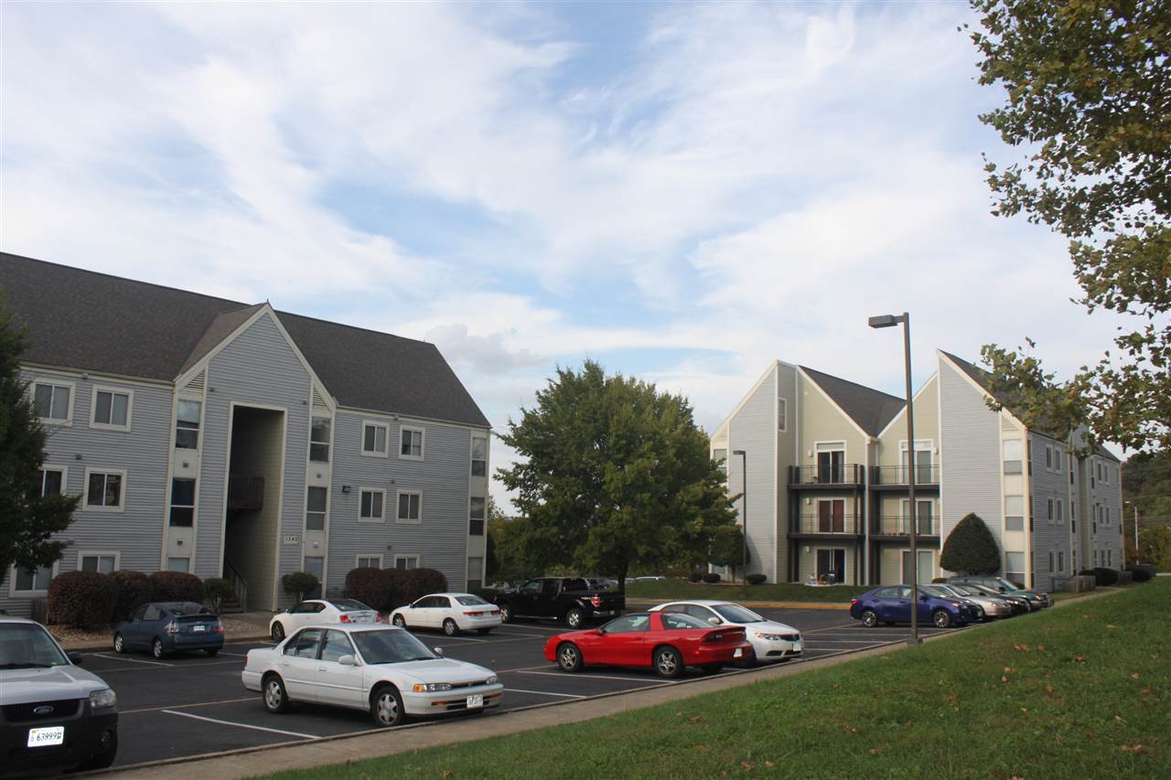 1372 Hunters Road, Unit B Harrisonburg, VA 22801 - Photo 18 of 22 a car parked in front of a white house