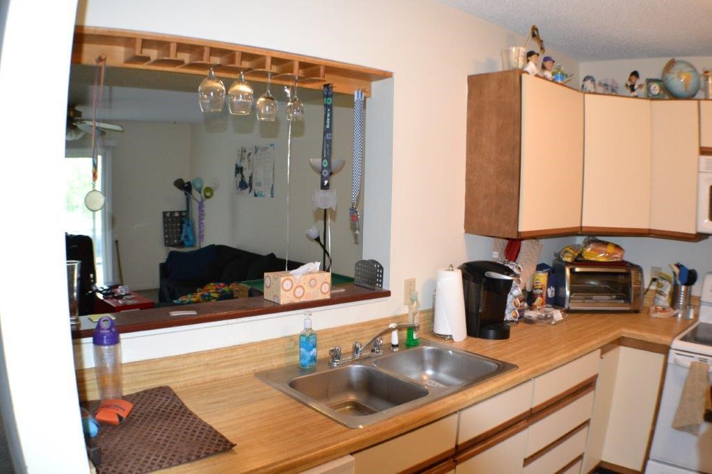 1372 Hunters Road, Unit B Harrisonburg, VA 22801 - Photo 10 of 22 a kitchen with a sink a counter top space and cabinets