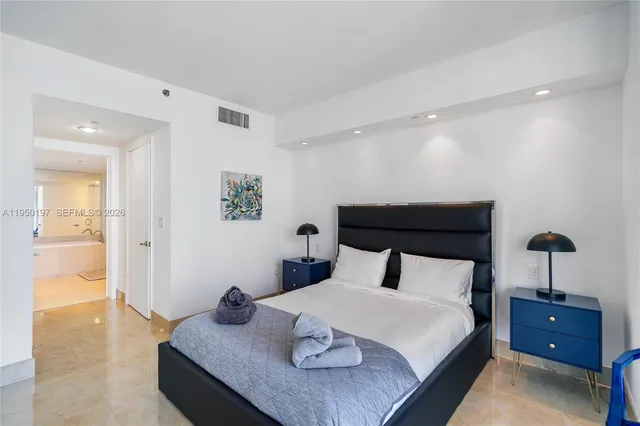 a bedroom with a bed and cabinets