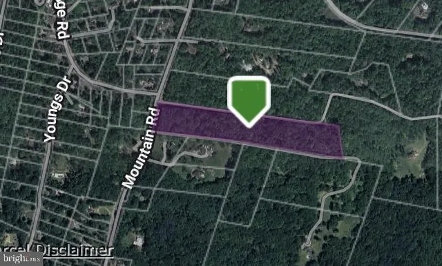 an aerial view of residential house with outdoor space and trees all around