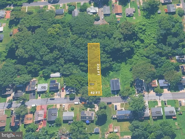 an aerial view of residential houses with outdoor space and street view