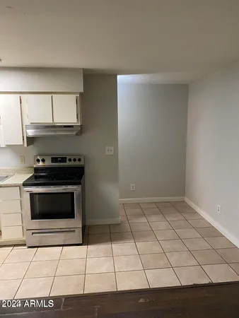 a kitchen with granite countertop a stove a microwave and a sink