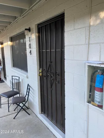 a living room with furniture a flat screen tv and a window