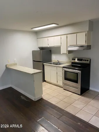 a kitchen with stainless steel appliances a stove a sink and a refrigerator