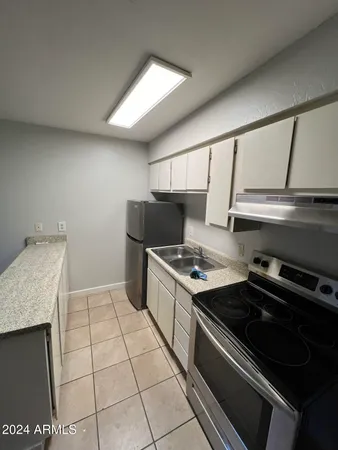 a kitchen with a stove and a sink