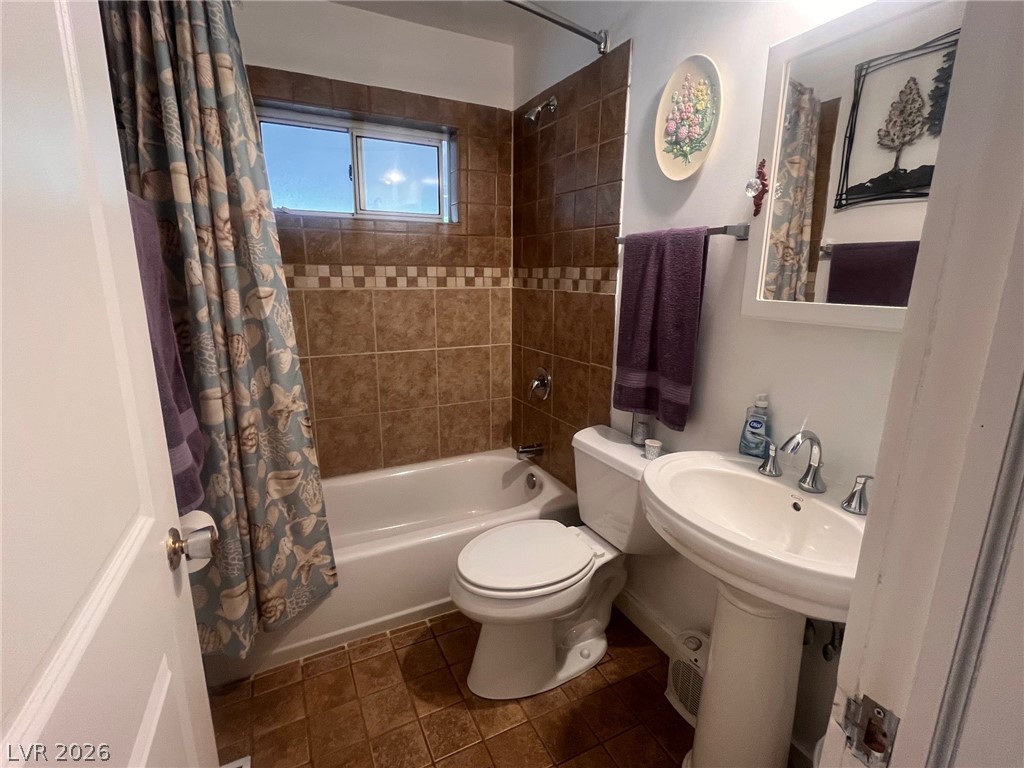 12 Reno Road Ely, NV 89301 - Photo 8 of 21 Bathroom featuring shower / bath combo with shower curtain and dark tile patterned flooring