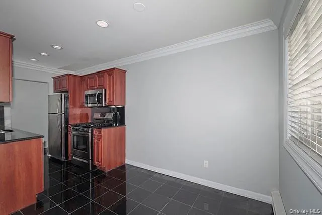 a kitchen with stainless steel appliances a refrigerator and a stove top oven