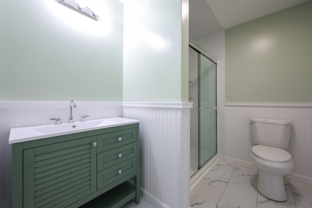 10 Nuttall Lane, Unit 1 Worcester, MA 01604 - Photo 12 of 28 a bathroom with a toilet sink and mirror