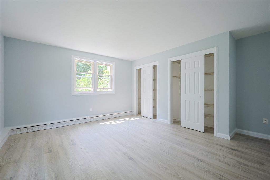 10 Nuttall Lane, Unit 1 Worcester, MA 01604 - Photo 14 of 28 an empty room with wooden floor and windows