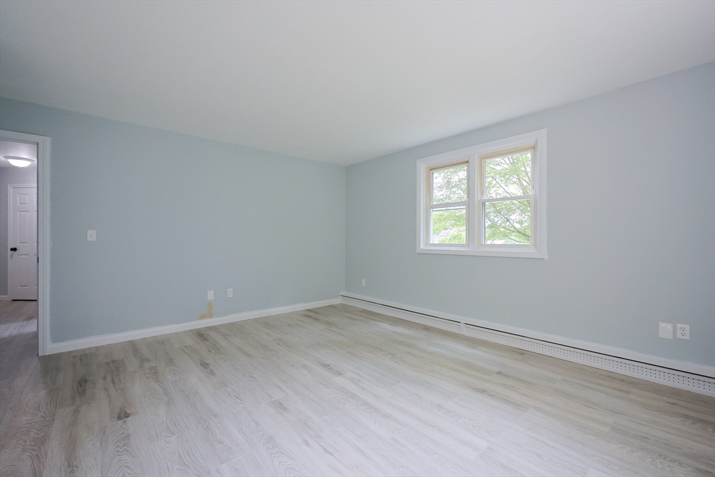 10 Nuttall Lane, Unit 1 Worcester, MA 01604 - Photo 16 of 28 an empty room with wooden floor and windows