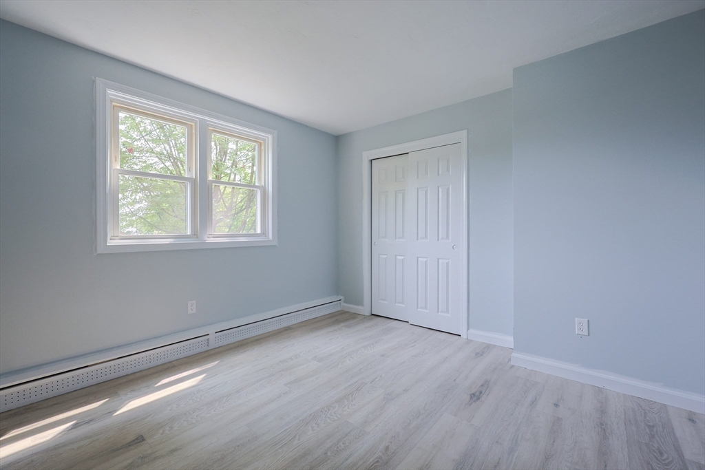 10 Nuttall Lane, Unit 1 Worcester, MA 01604 - Photo 20 of 28 an empty room with wooden floor and windows