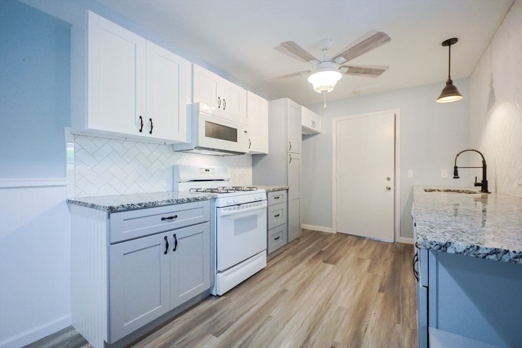 10 Nuttall Lane, Unit 1 Worcester, MA 01604 - Photo 2 of 28 a kitchen with granite countertop a sink stainless steel appliances and cabinets