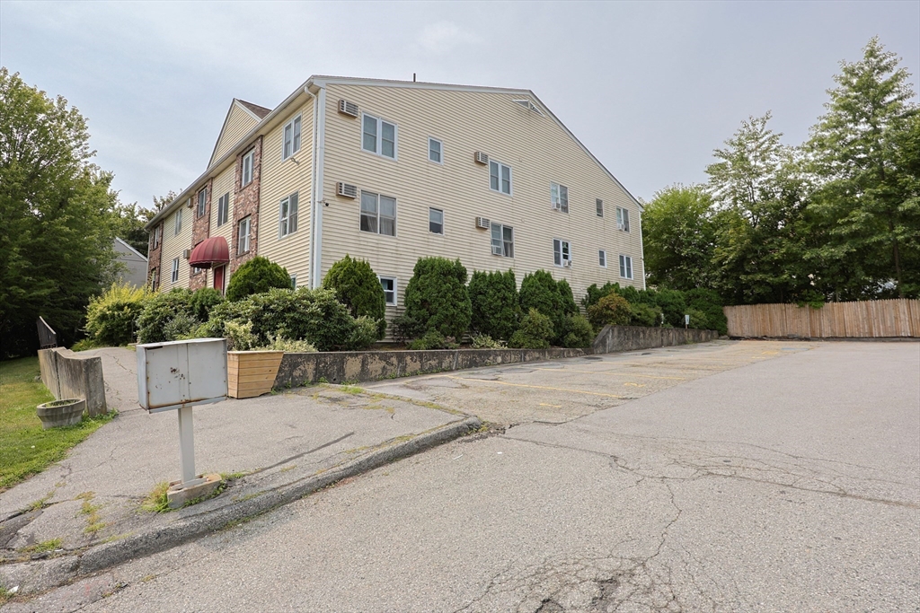 10 Nuttall Lane, Unit 1 Worcester, MA 01604 - Photo 22 of 28 a view of a building with potted plants and wooden fence