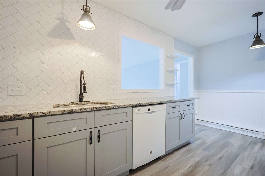 10 Nuttall Lane, Unit 1 Worcester, MA 01604 - Photo 5 of 28 a kitchen with granite countertop white cabinets and white appliances