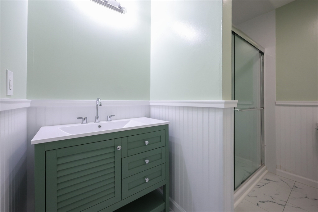 10 Nuttall Lane, Unit 1 Worcester, MA 01604 - Photo 9 of 28 a bathroom with a sink and mirror