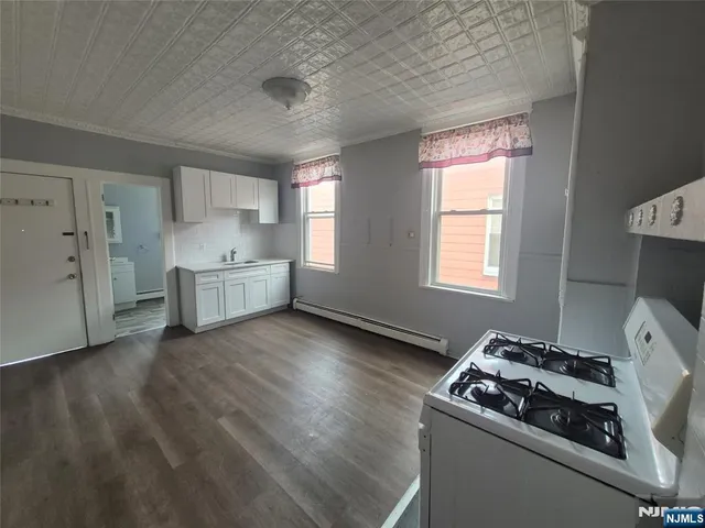 a kitchen that has a stove and cabinets