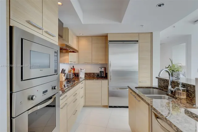 a bedroom with a large bed and a balcony