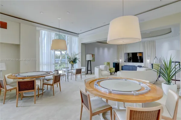 a view of a dining room with furniture wooden floor and chandelier
