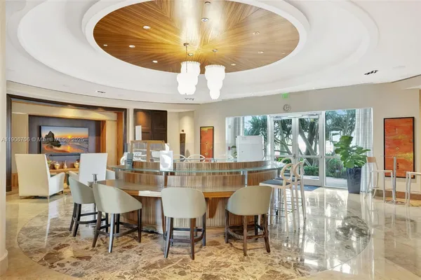 a dining room with furniture and a large window