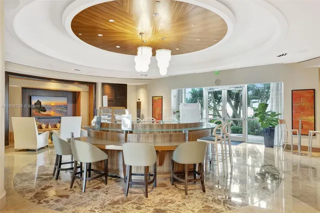 a dining room with furniture and a large window