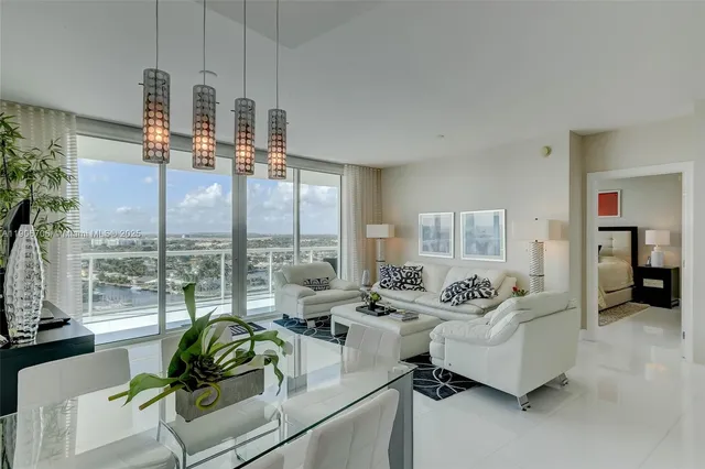 a living room with furniture and a floor to ceiling window
