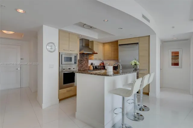 a kitchen with white cabinets and appliances