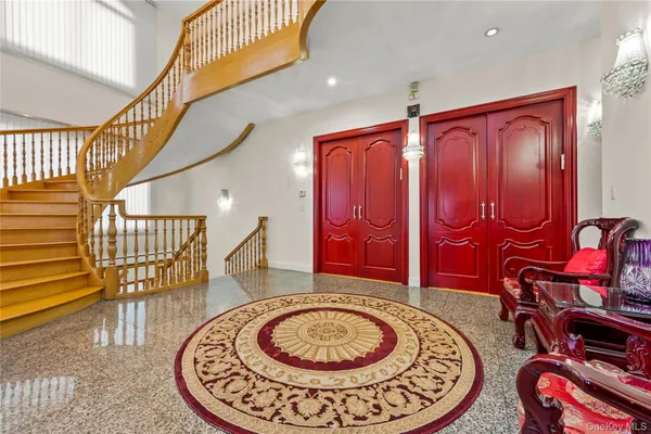 a view of an entryway with a table and chairs