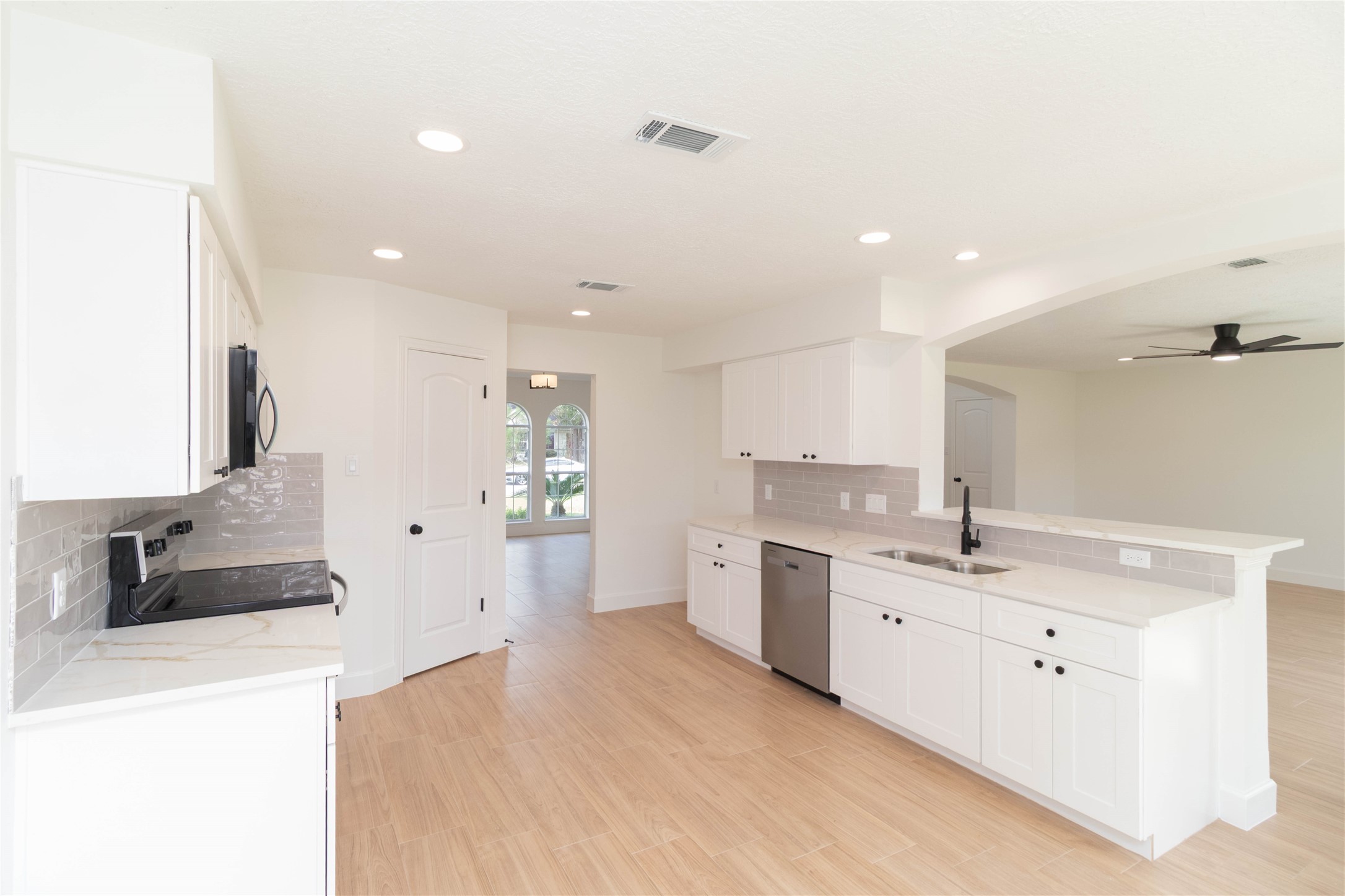 415 Binnacle Way Crosby, TX 77532 - Photo 12 of 50 a large white kitchen with a sink and dishwasher