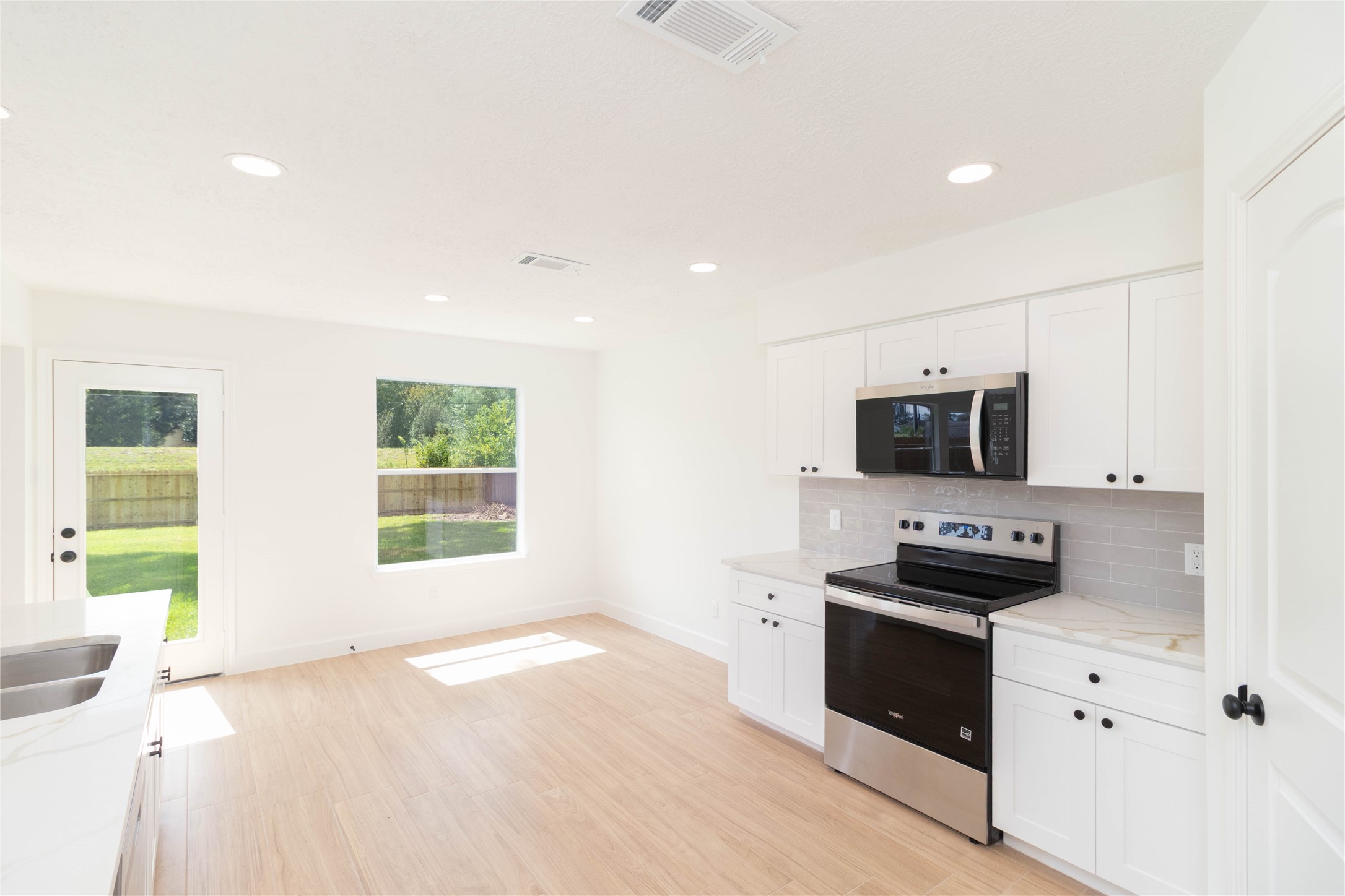 415 Binnacle Way Crosby, TX 77532 - Photo 13 of 50 a kitchen with stainless steel appliances a stove a sink and a microwave