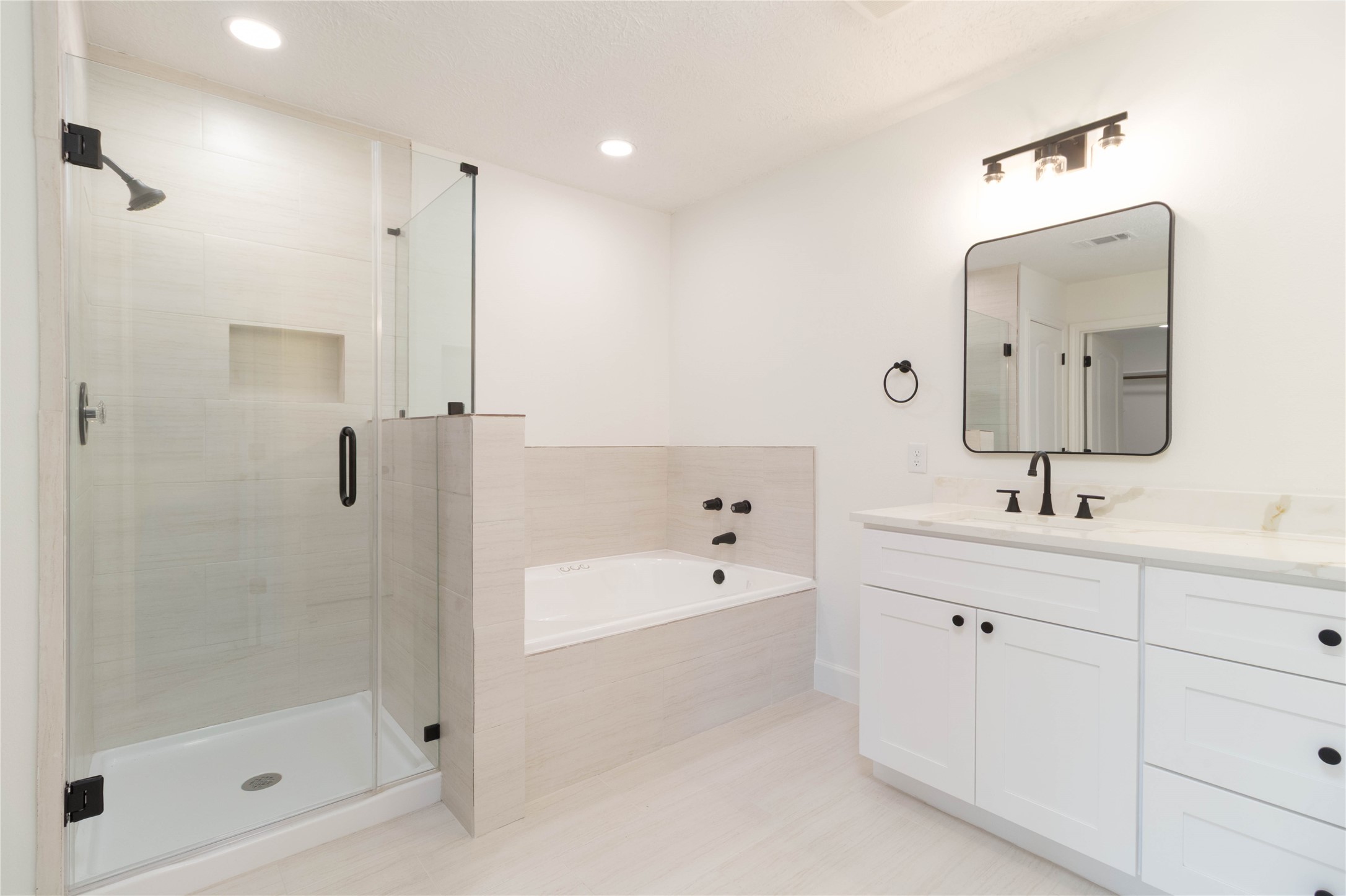 415 Binnacle Way Crosby, TX 77532 - Photo 19 of 50 a spacious bathroom with a bathtub shower sink and mirror