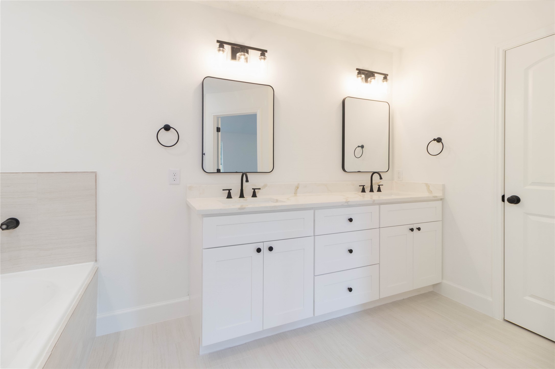 415 Binnacle Way Crosby, TX 77532 - Photo 20 of 50 a bathroom with double vanity sinks double vanity tub and a mirror