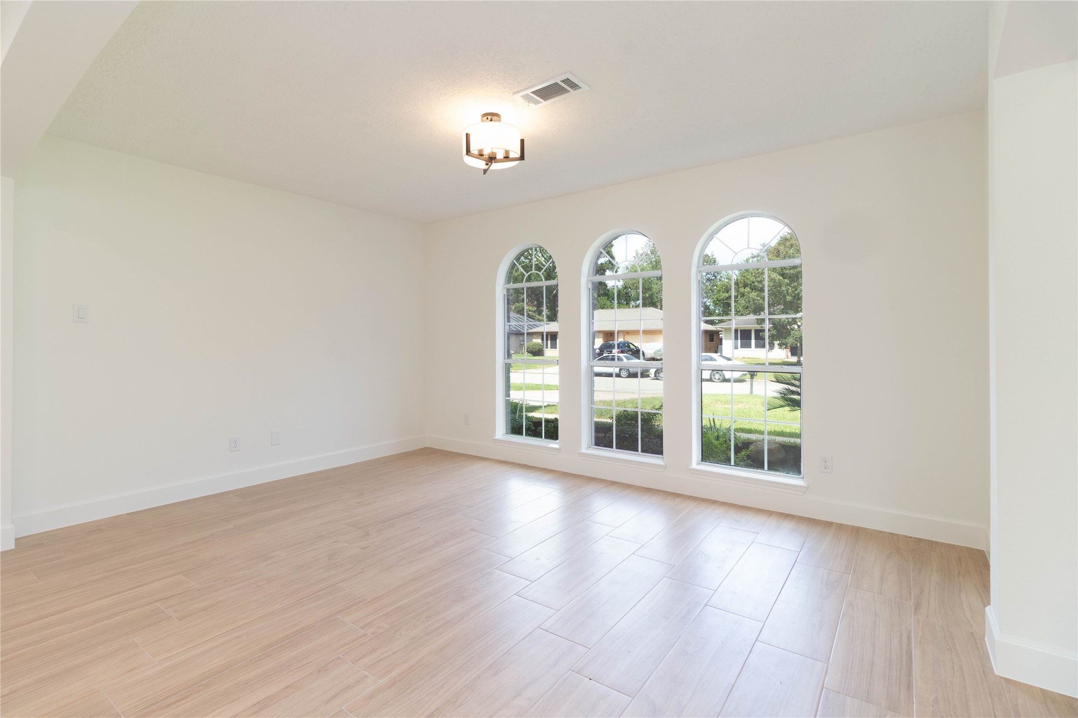 415 Binnacle Way Crosby, TX 77532 - Photo 7 of 50 an empty room with wooden floor fan and windows