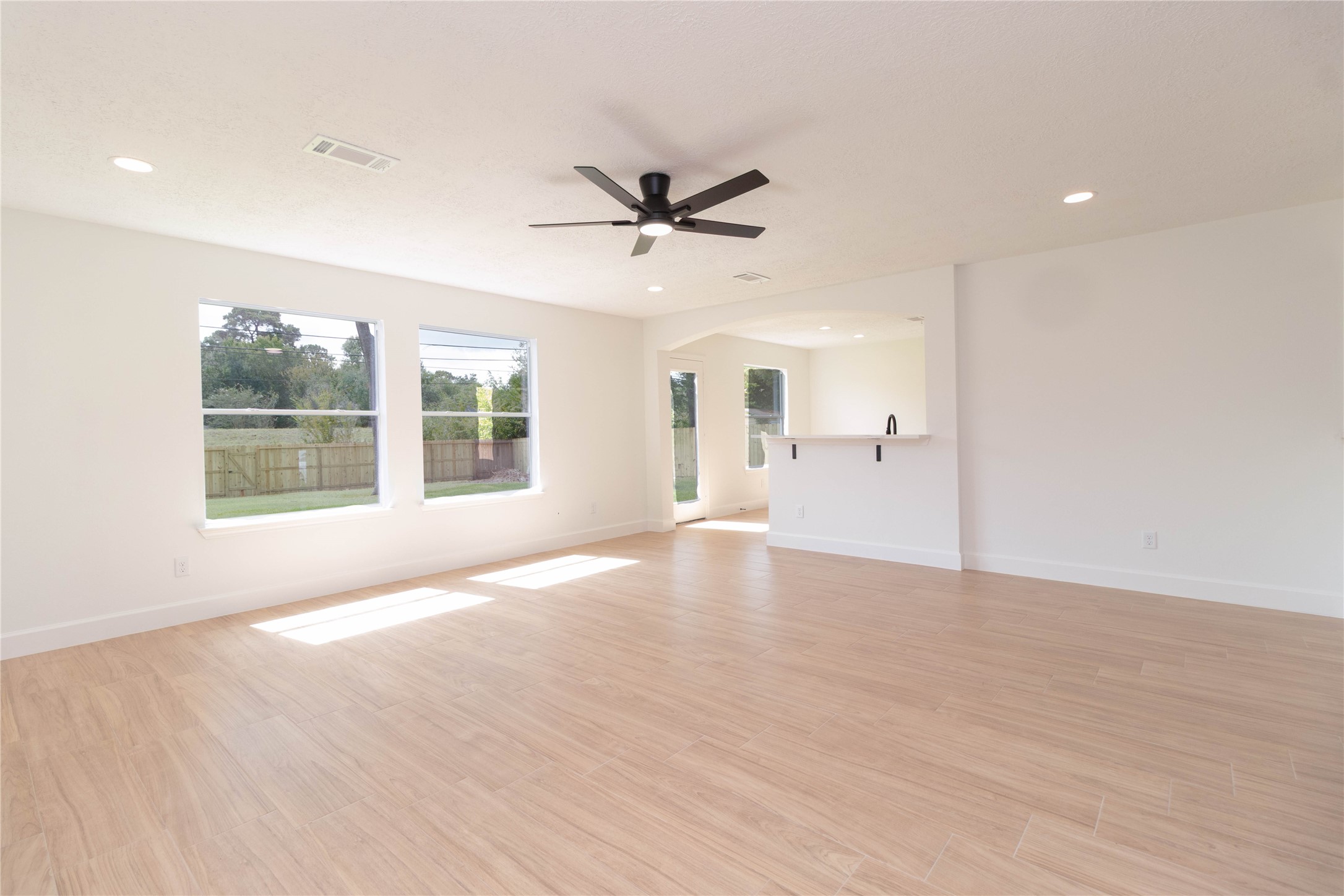 415 Binnacle Way Crosby, TX 77532 - Photo 9 of 50 a view of an empty room with a window and wooden floor
