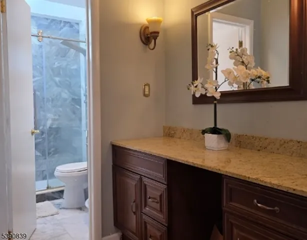 a view of bathroom with a sink and mirror