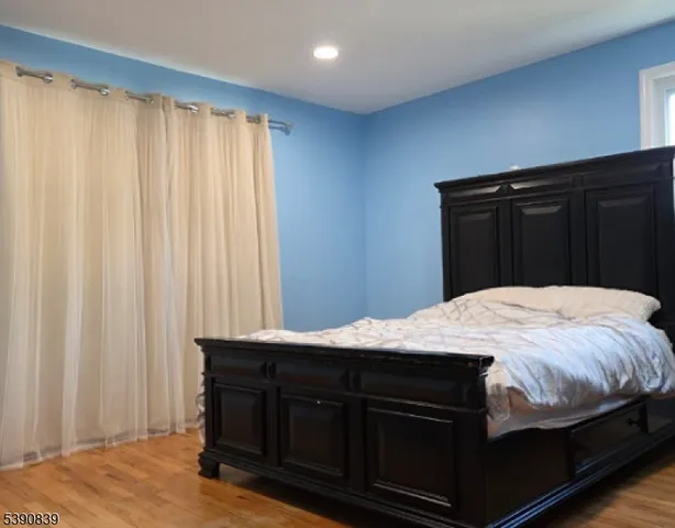 a bed sitting in a bedroom with a sink