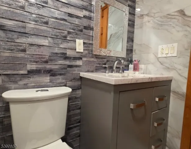 a bathroom with a sink toilet and mirror