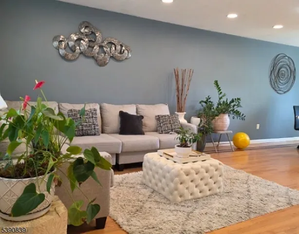a living room with furniture and flowers