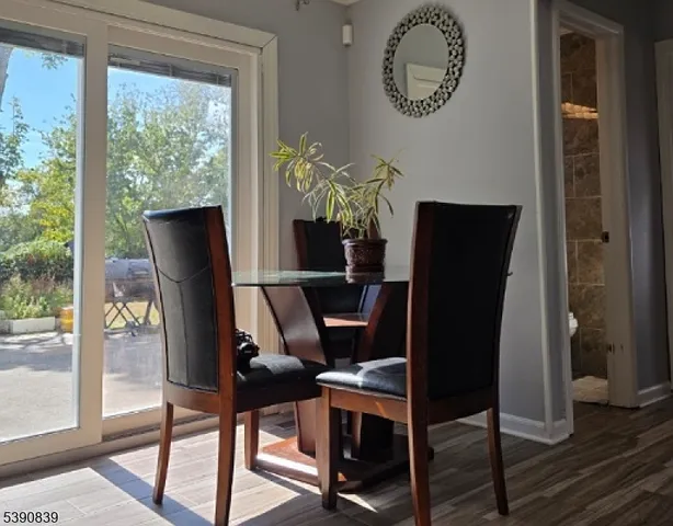 a dining room with furniture and wooden floor