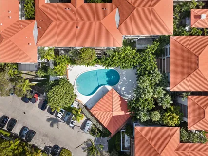 an aerial view of a house with a yard and plants