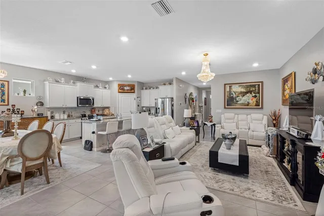 a living room with lots of furniture and a chandelier