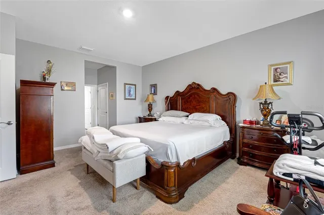 a spacious bedroom with a bed and a couch